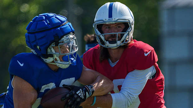 Indianapolis Colts quarterback Gardner Minshew (10) hands off to Indianapolis Colts running back Evan Hull (26) on Monday, July 31, 2023, during training camp at the Grand Park Sports Campus in Westfield, Indiana.